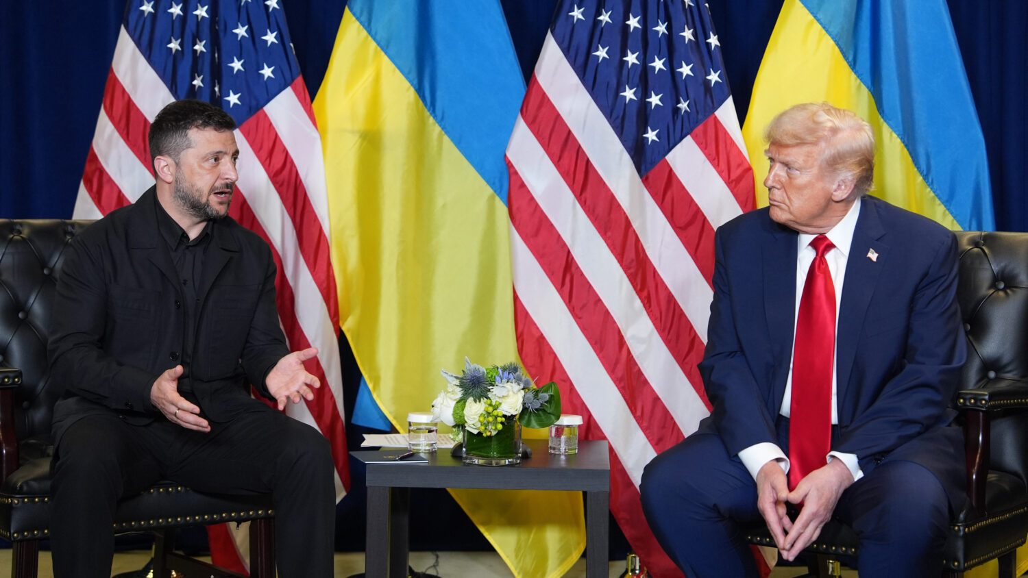 President Donald Trump sits with Ukrainian President Volodymyr Zelenskyy in front of Ukrainian and ...