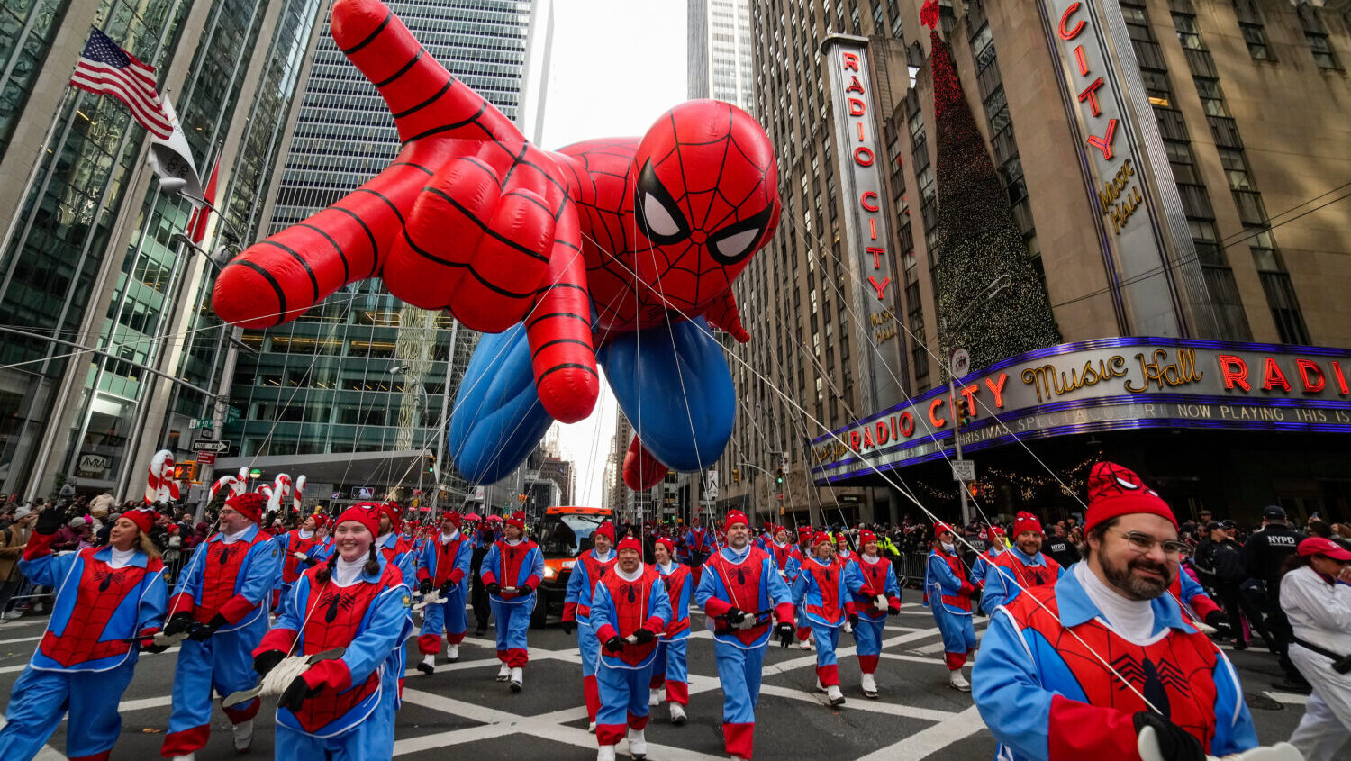 Balloon handlers guide the Spider Man balloon past Radio City Music Hall during the Macy's Thanksgi...