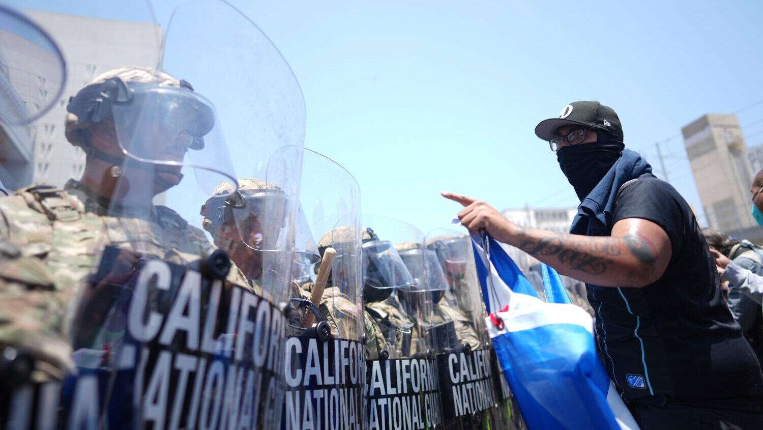 FILE - A protester confronts a line of U.S. National Guard in the metropolitan detention center of ...
