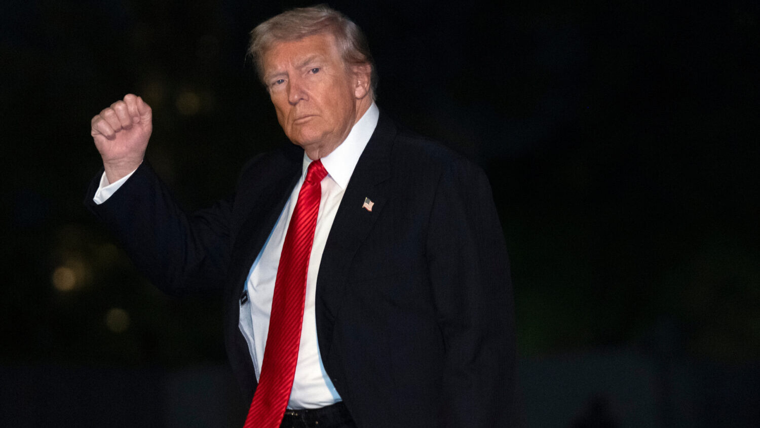 President Donald Trump gestures while walking across the South Lawn of the White House, Sunday, Nov...