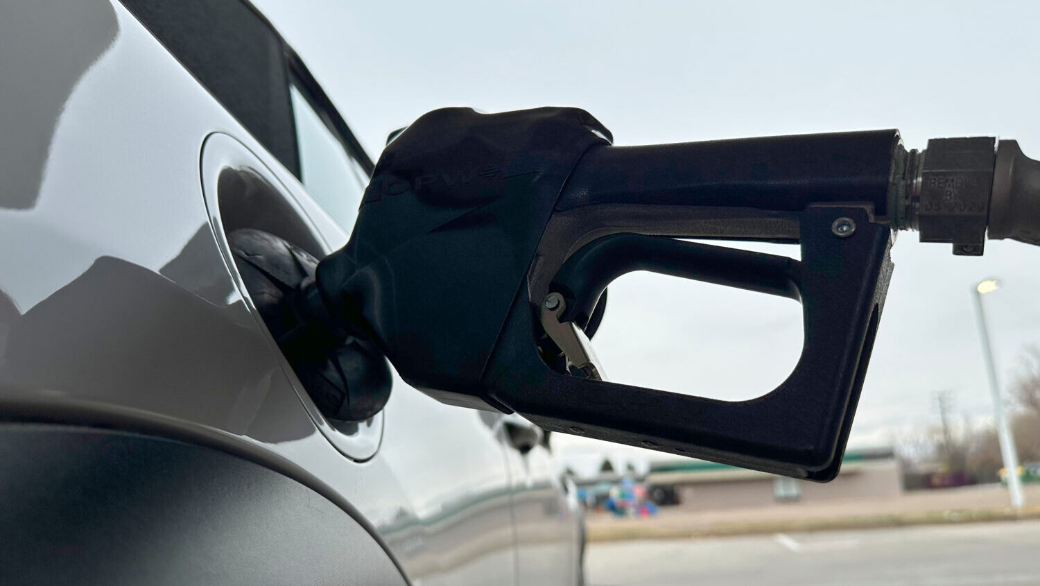 FILE - A motorist fills up the tank of a vehicle at a gasoline station Sunday, Nov. 30, 2025, in Li...