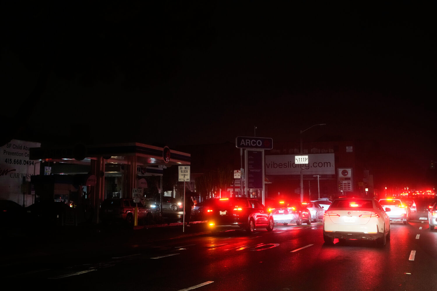 Cars wait at an intersection with no working traffic lights from power outages, in San Francisco, S...