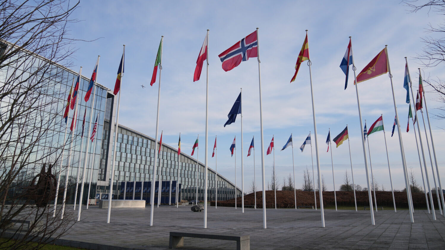 Flags flap in the wind outside NATO headquarters in Brussels, Monday, Jan. 19, 2026....