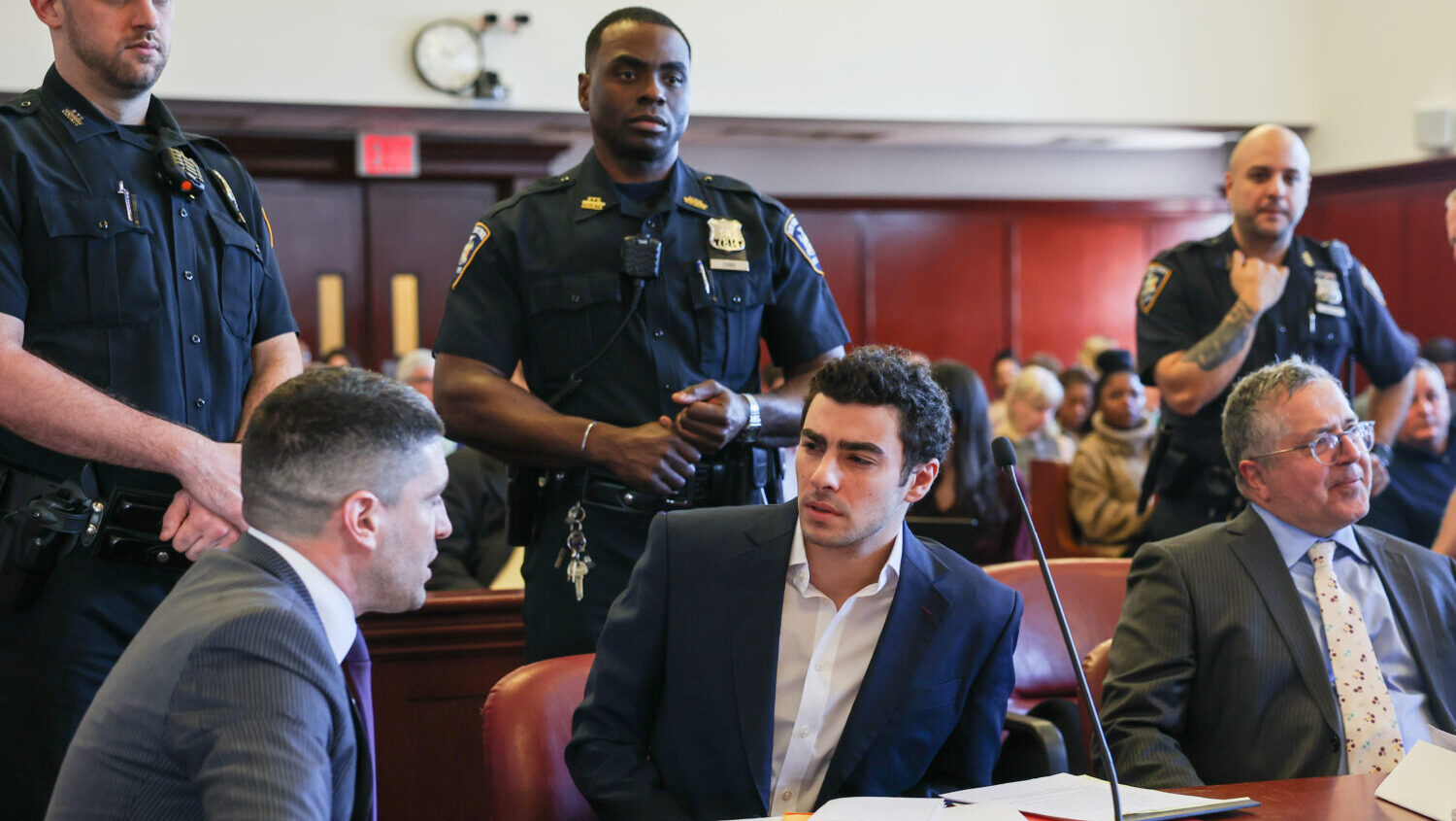 FILE - Luigi Mangione appears in Manhattan Criminal Court for an evidence hearing, Dec. 18, 2025, i...