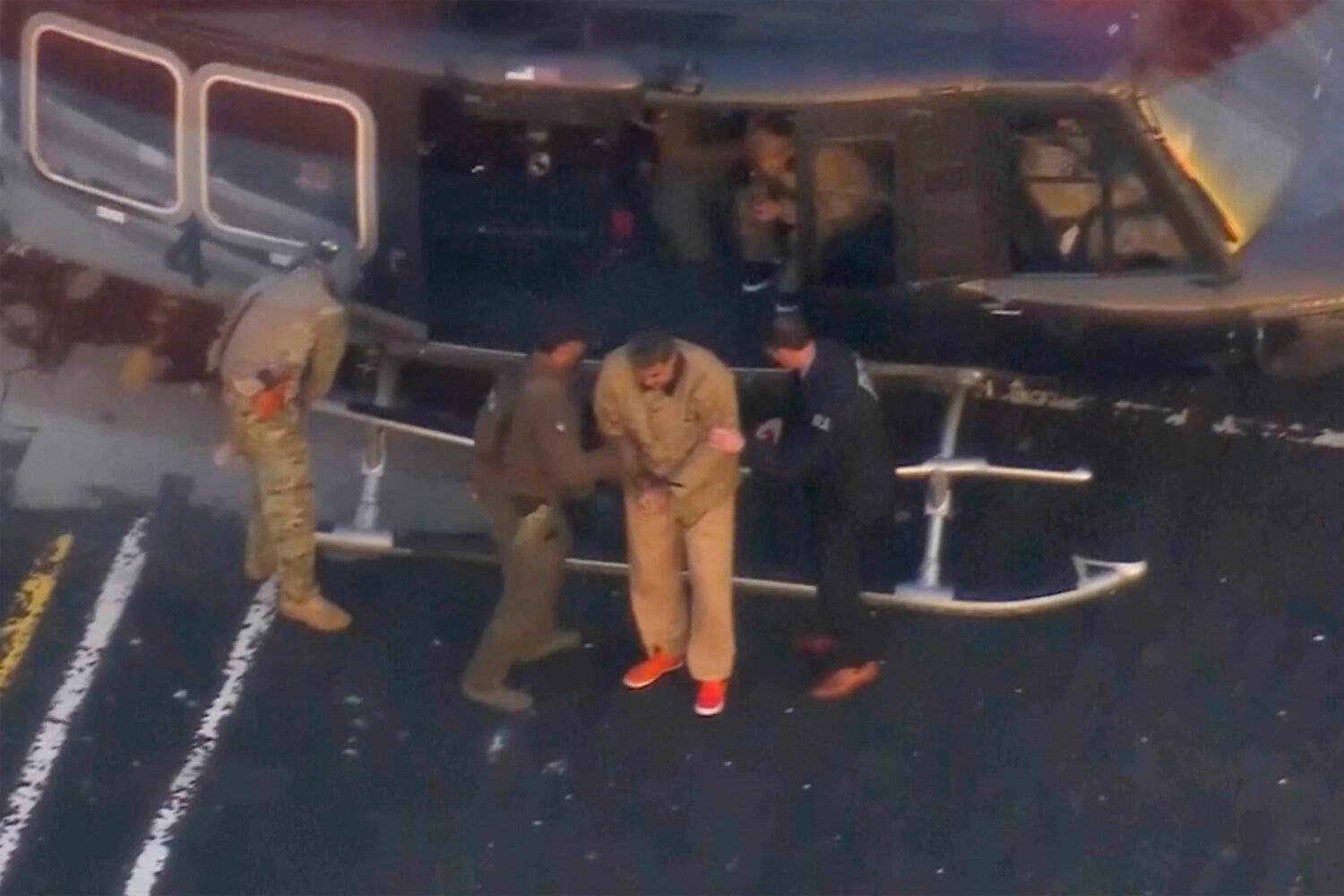 This image taken video shows Venezuelan President Nicolas Maduro getting off a helicopter on his wa...