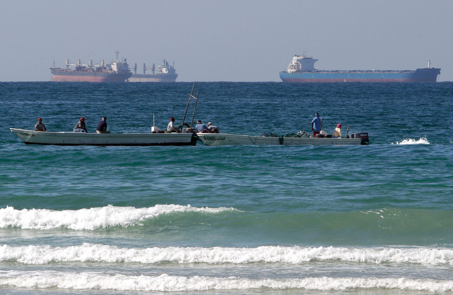 FILE - Fishermen work in front of oil tankers south of the Strait of Hormuz Jan. 19, 2012, offshore...
