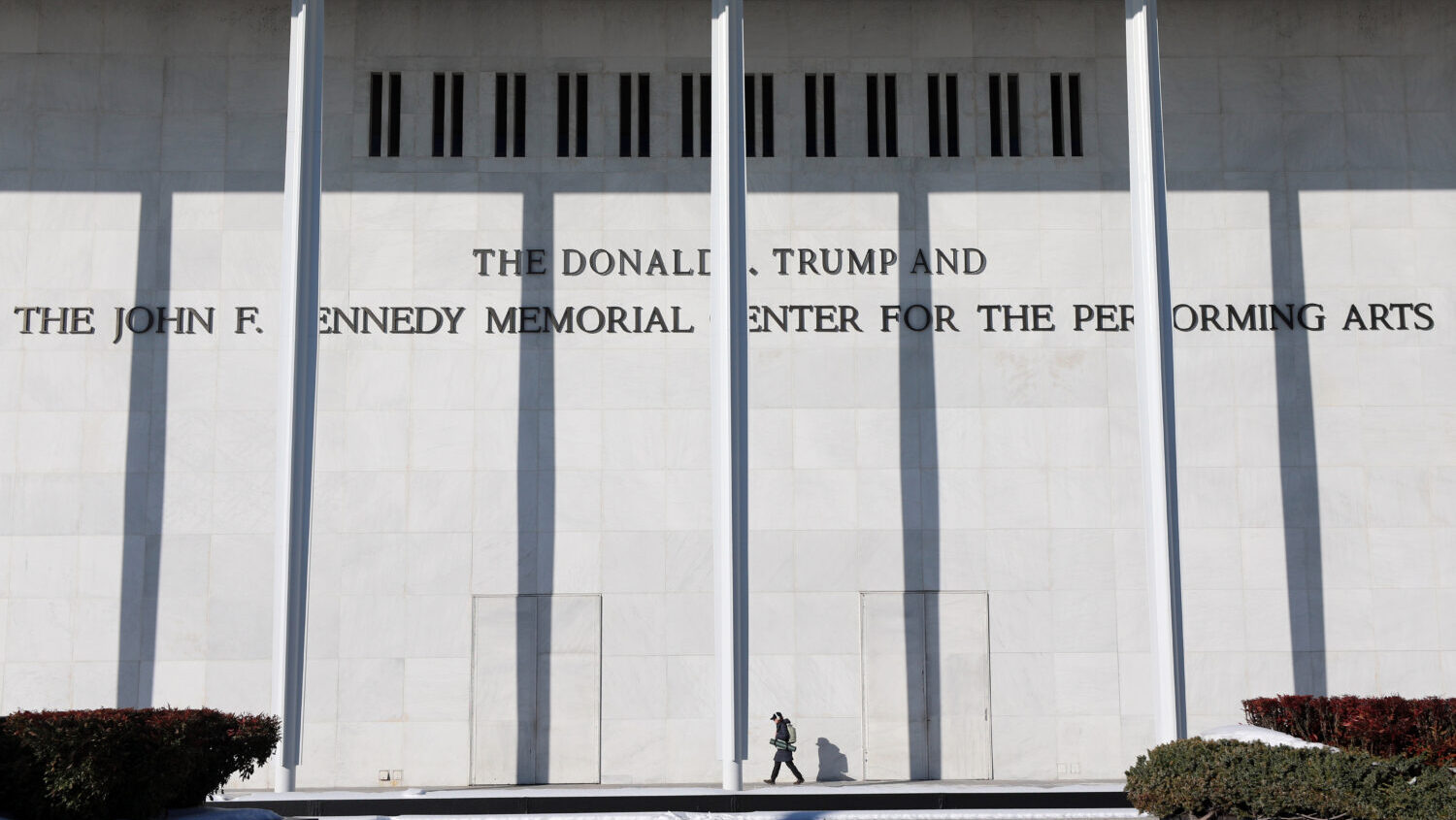 A woman walks outside The John F. Kennedy Memorial Center For The Performing Arts on Feb. 2, 2026, ...