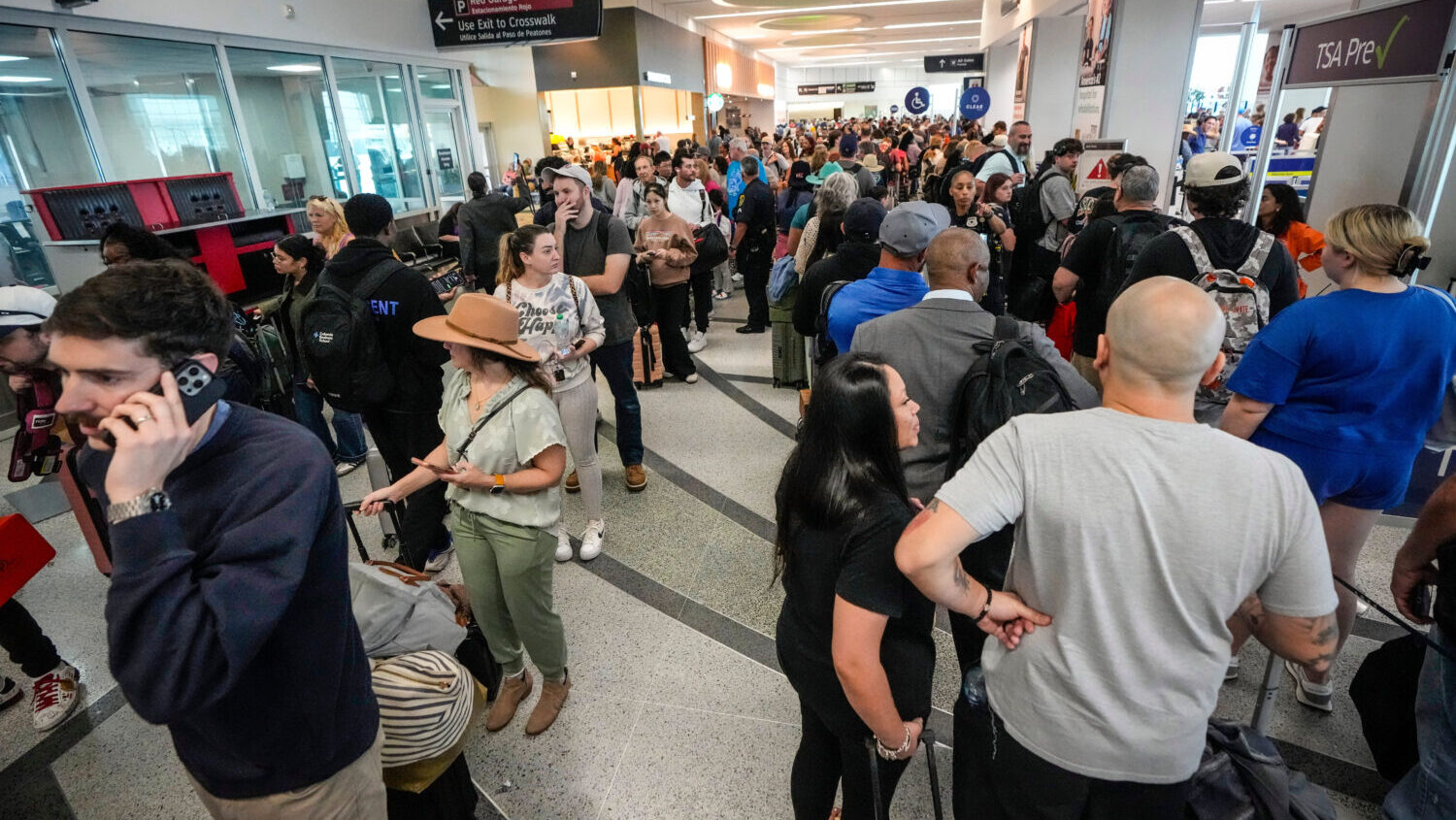 Airline passengers wait in long lines to get through the TSA security screening at William P. Hobby...