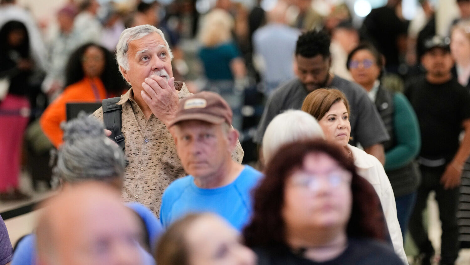 Passengers wait in a security checkpoint line at George Bush Intercontinental Airport, Wednesday, M...