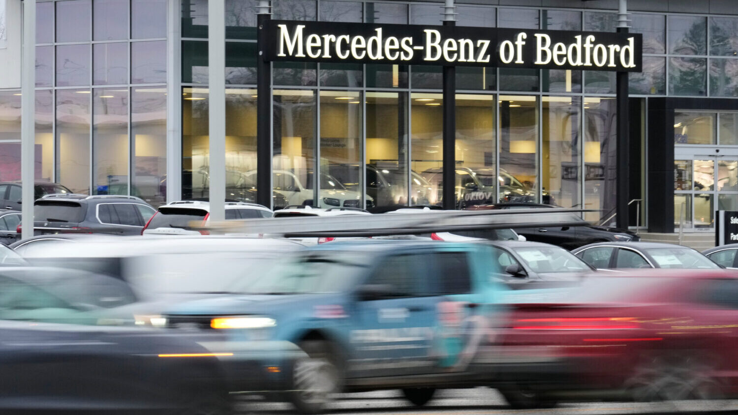 Cars drive by a Mercedes-Benz dealership on the Bedford Automile in Bedford, Ohio, Friday, Feb. 20,...