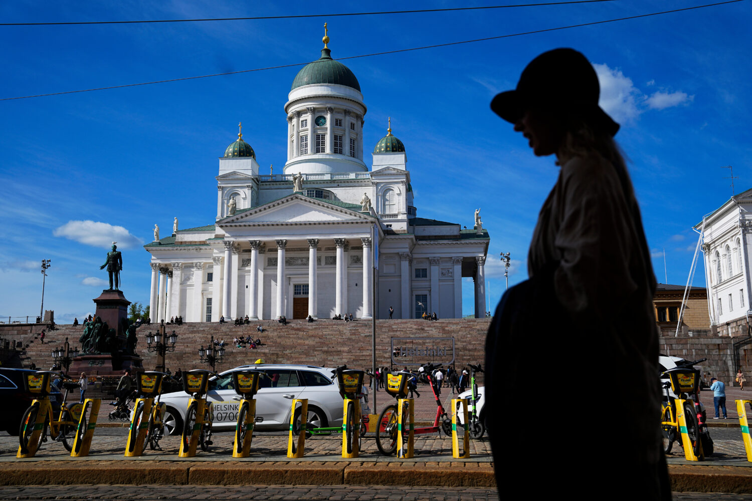 FILE - A woman walks past the Helsinki Cathedral in Helsinki, May 29, 2023. (Pavel Golovkin, Associ...