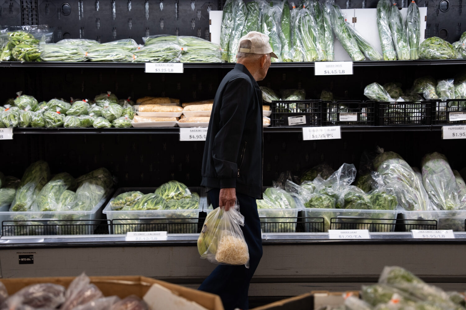 A customer walks by produce at a grocery store in Portland, Ore., Wednesday, April 8, 2026 as the k...