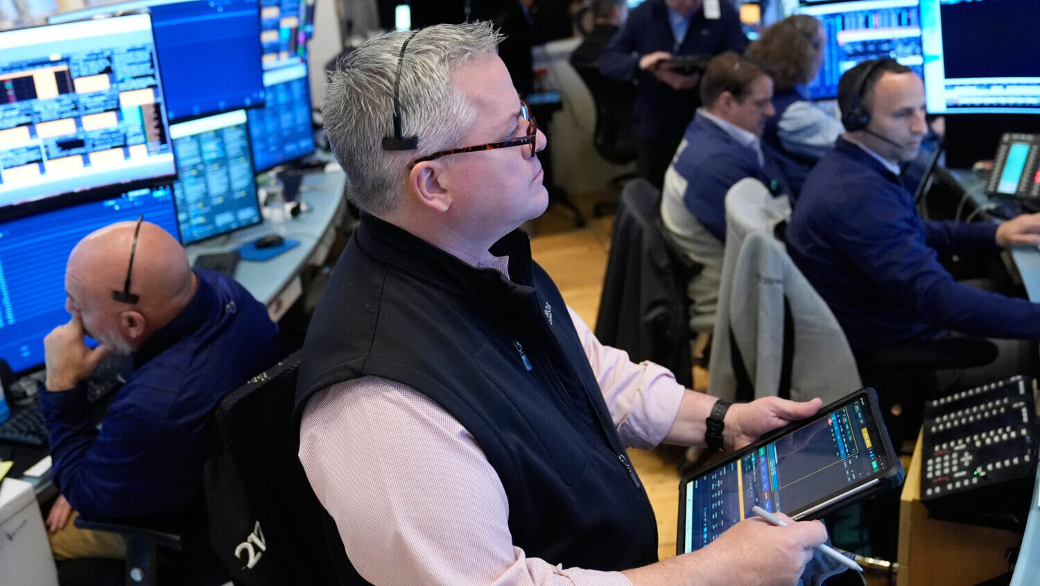 People work on the floor at the New York Stock Exchange in New York, Monday, April 13, 2026....
