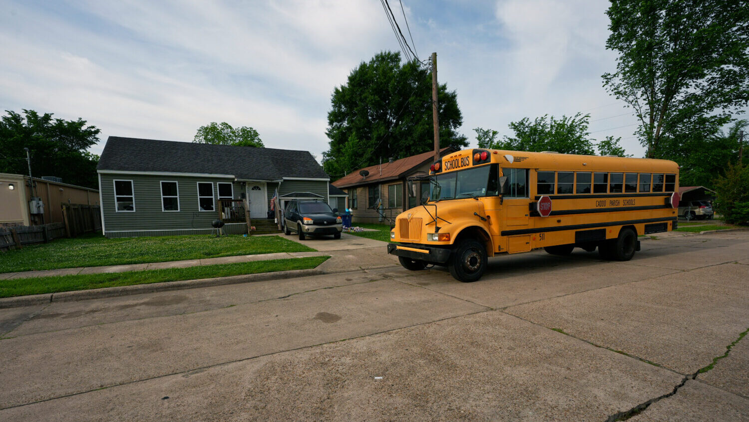 A school bus passes the house where 8 children were killed during a mass shooting the day before in...