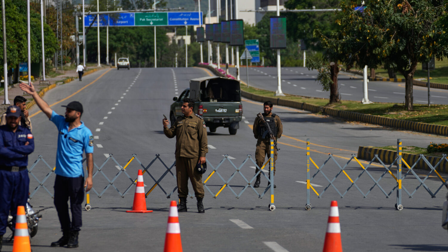 Police officers stand guard at a checkpoint ahead of the second round of negotiations between the U...