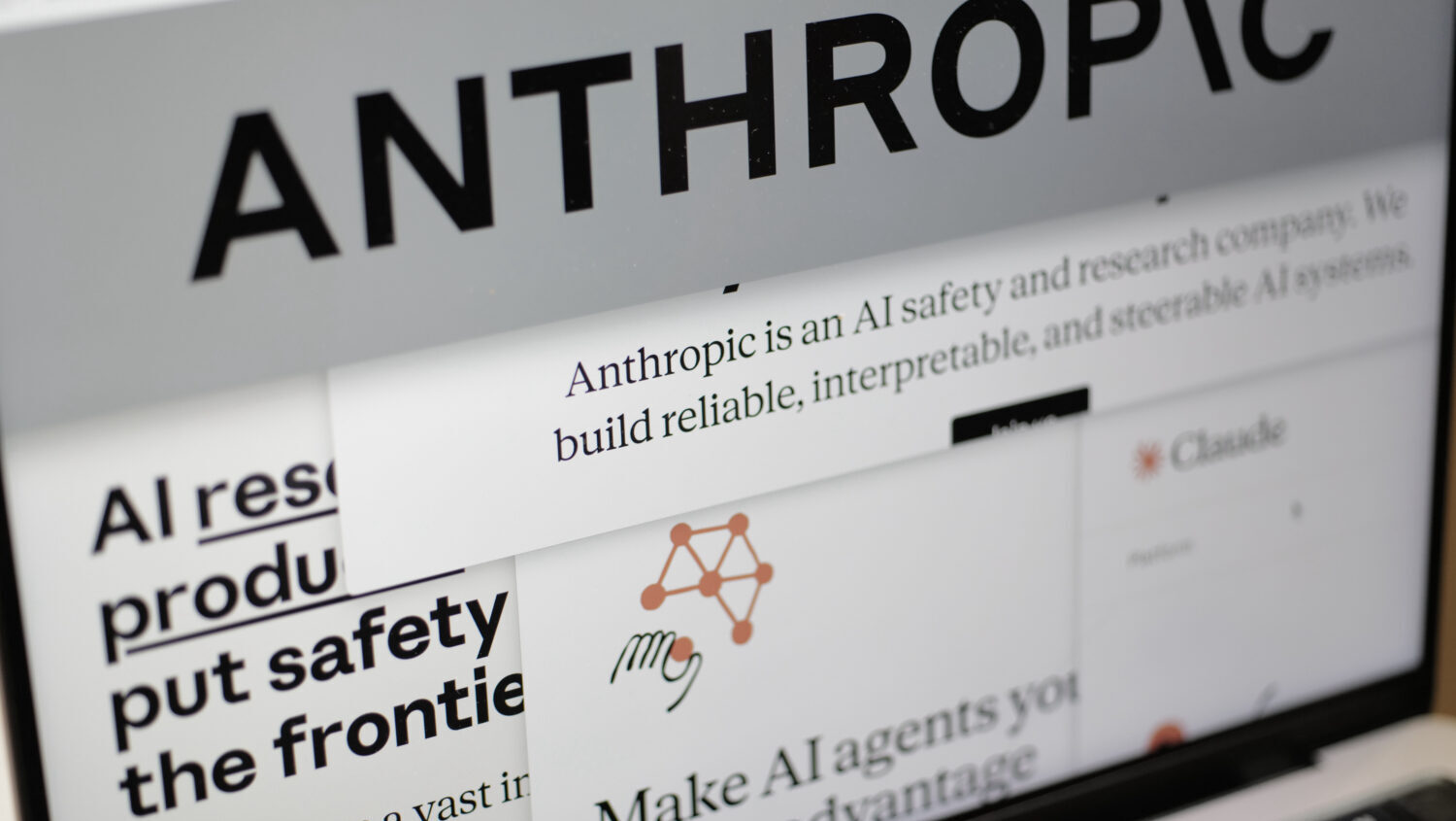 FILE - Pages from the Anthropic website and the company's logo are displayed on a computer screen i...