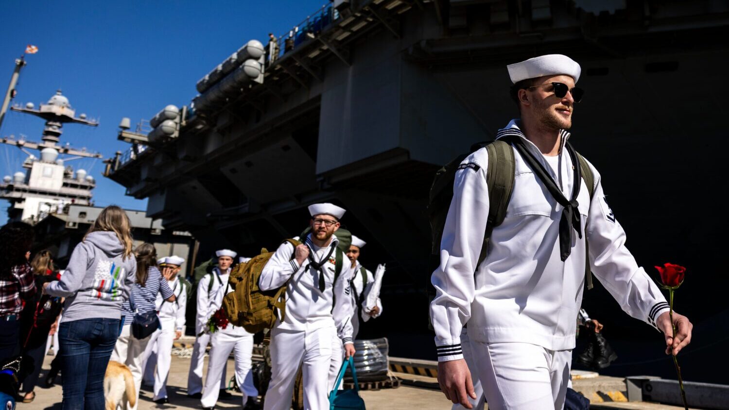Sailors make their way to their loved ones after disembarking from the USS Gerald R. Ford at Naval ...