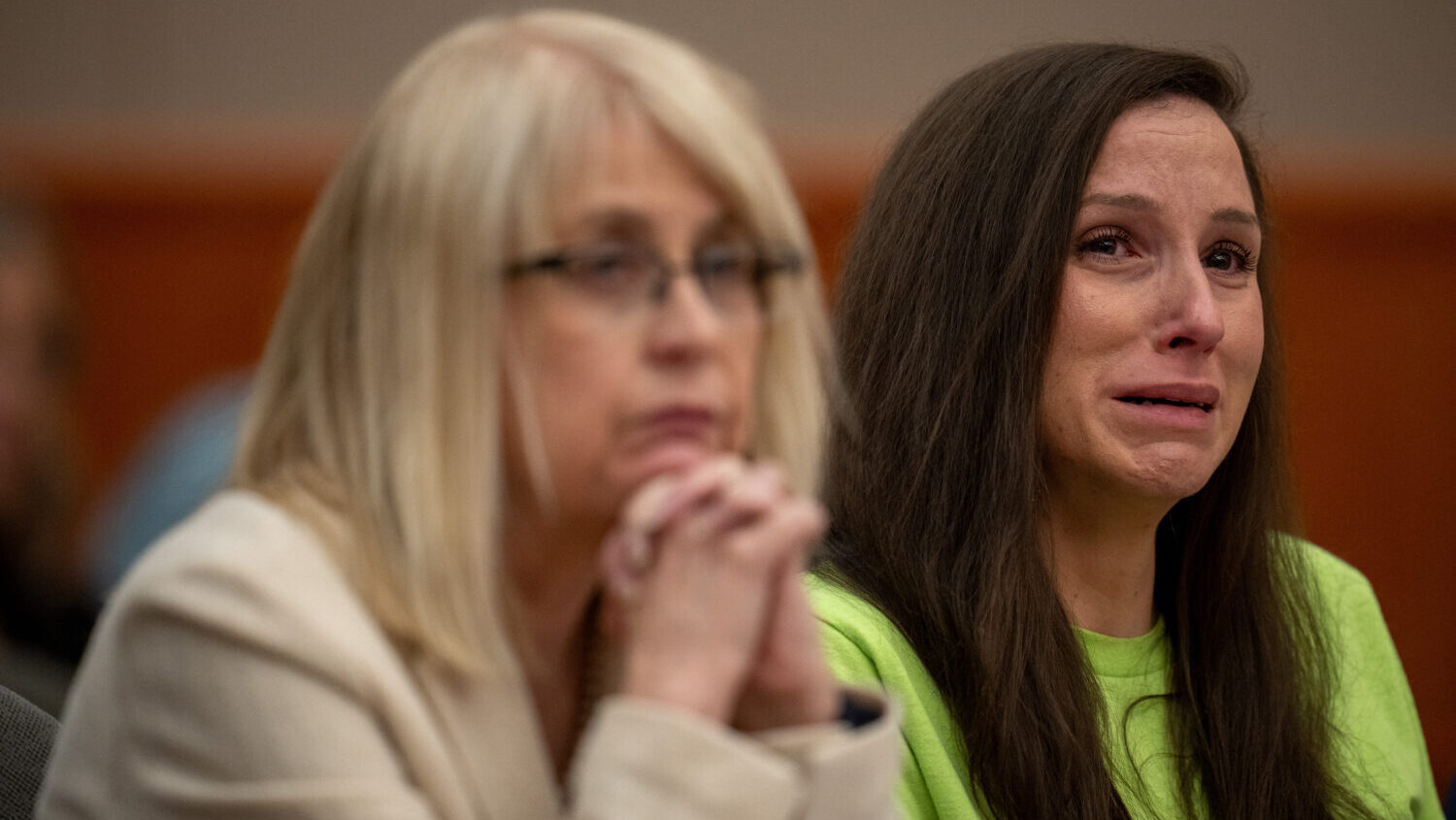 Kouri Richins, right, reacts as her brother, Ronney Darden, speaks on her behalf during her sentenc...