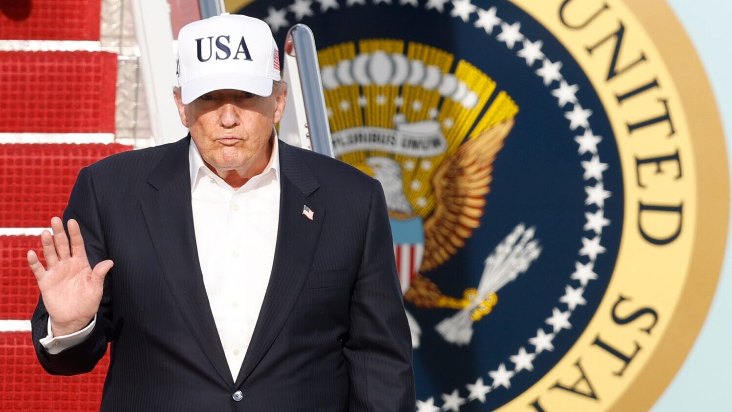 President Donald Trump walks down the stairs of Air Force One upon his arrival at Joint Base Andrew...