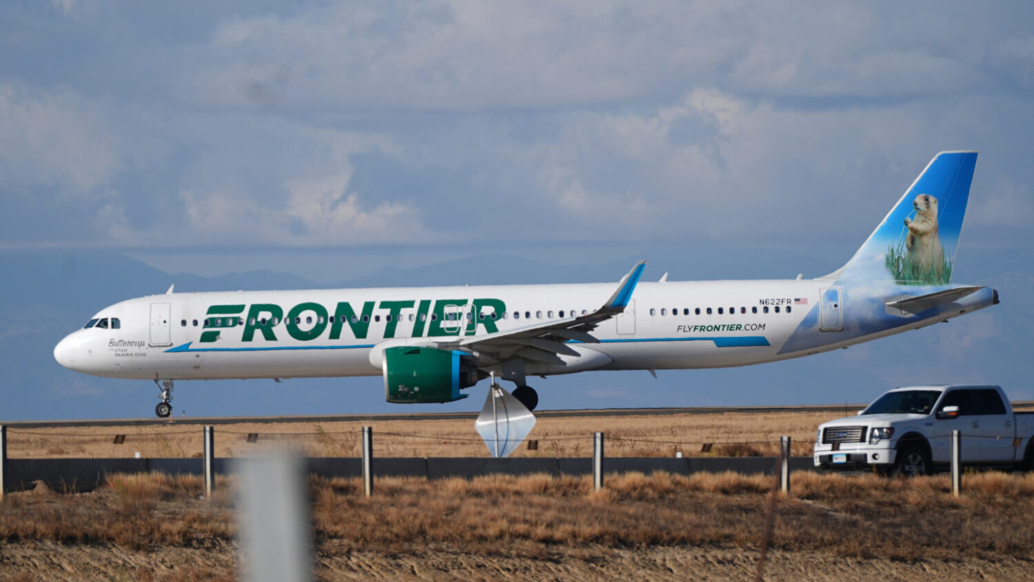FILE - A Frontier Airlines jetliner taxis down a runway for take off from Denver International airp...