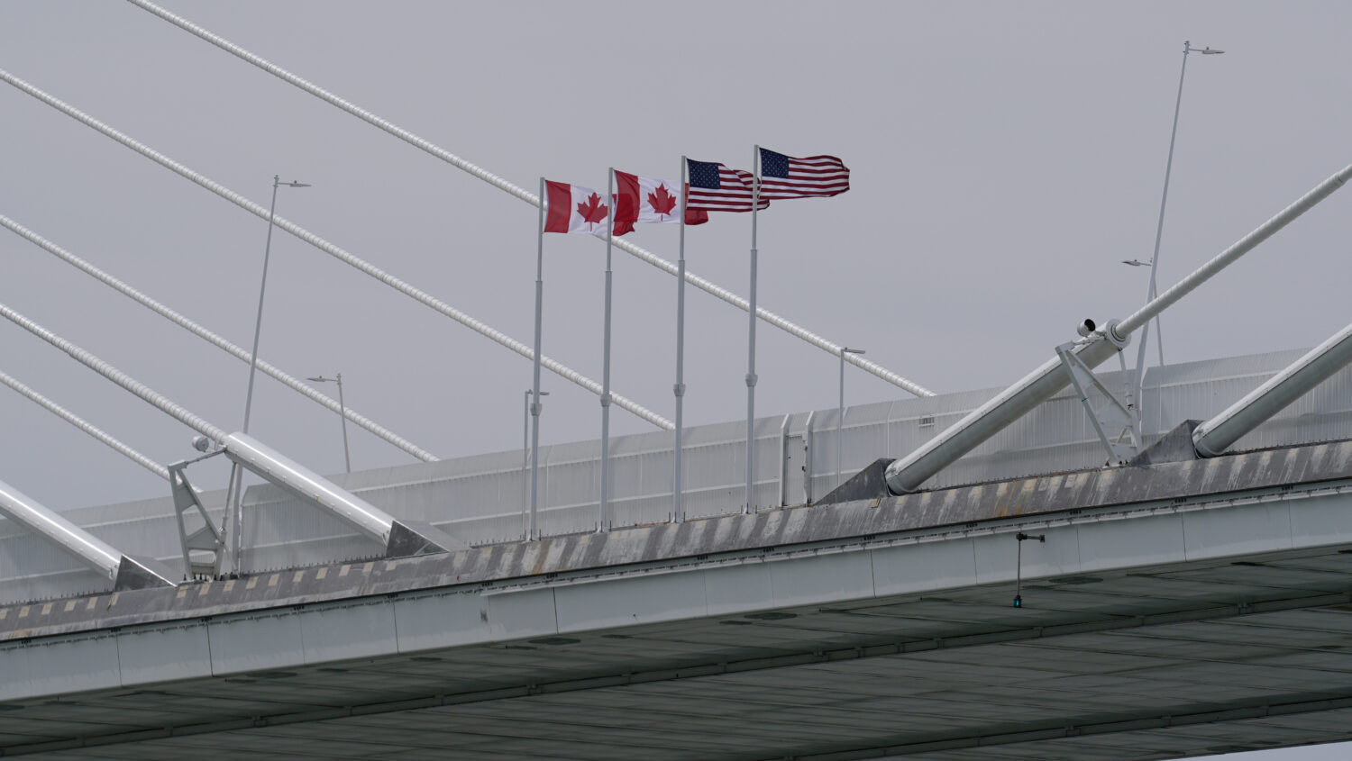 FILE - Canadian and American flags are shown on the Gordie Howe Bridge under construction between W...
