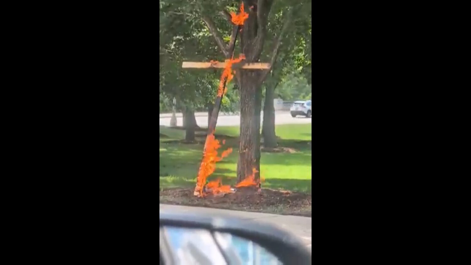 This framegrab from a video taken by motorist Keinika Carlton shows a wooden cross engulfed in brig...