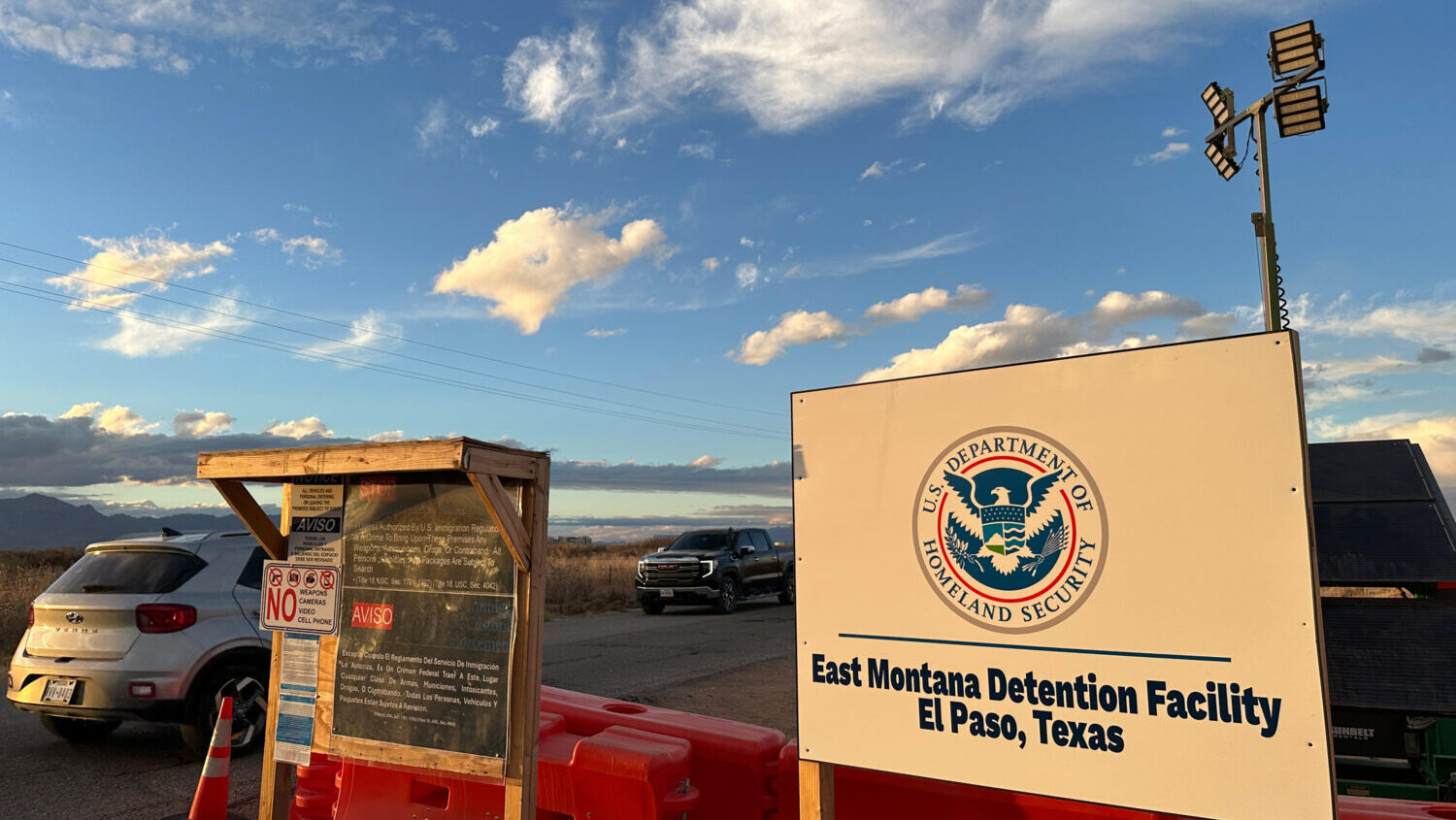FILE - A sign marks the entrance to a series of hardened tents at the Camp East Montana immigrant d...