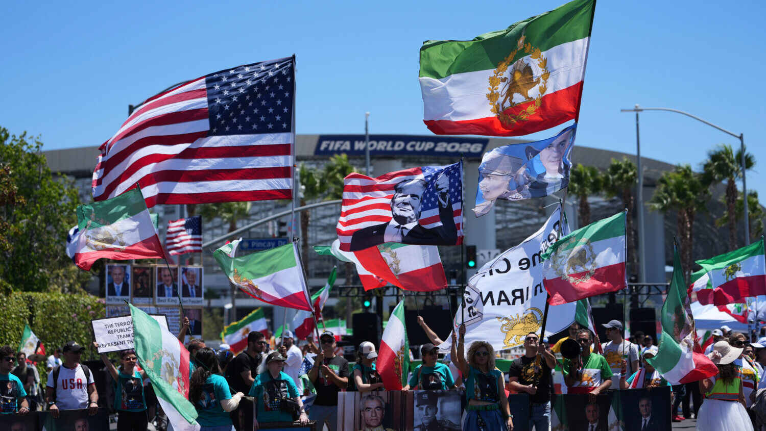 People protest outside Los Angeles Stadium before the World Cup Group G soccer match between Iran a...